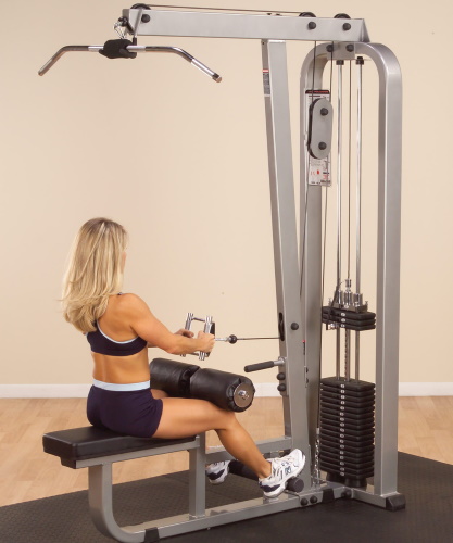 Tração vertical da máquina de exercício. Técnica para sentar, de costas, atrás da cabeça, com pegada estreita para mulheres