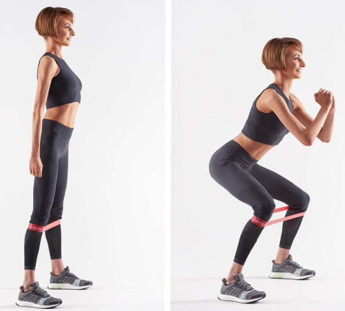 Squats dengan elastik pada kaki untuk punggung. Kesan otot mana yang berfungsi